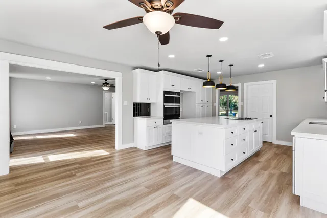 a view of kitchen with cabinets and wooden floor