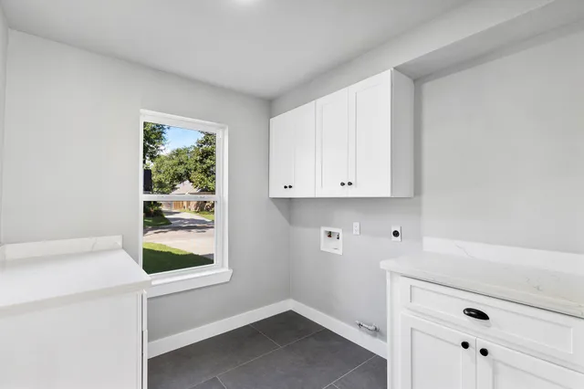 a view of storage and utility room with two washing machine