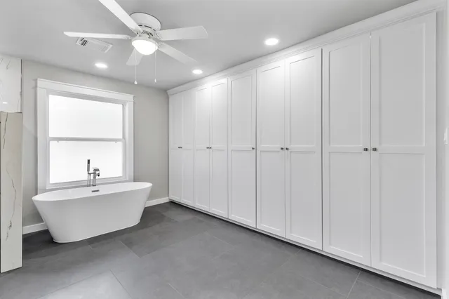 a spacious bathroom with a bathtub and a sink