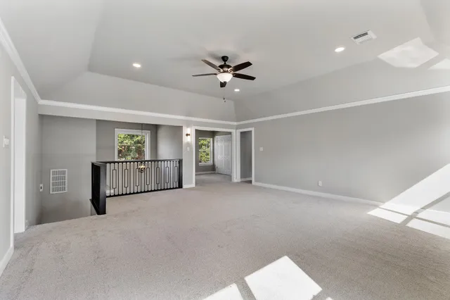 a view of a livingroom with a ceiling fan and window