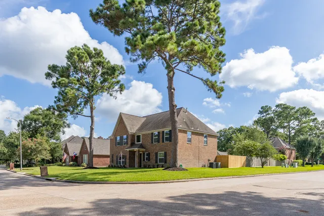 a front view of a house with a yard and a garage