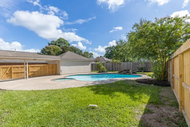a view of backyard with swimming pool and outdoor seating