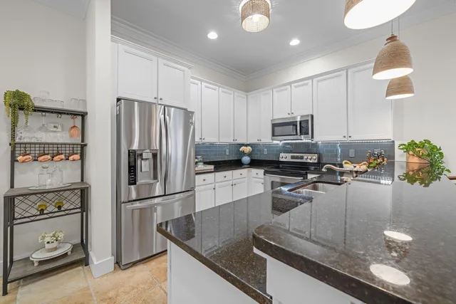 a view of a backyard with potted plants and wooden fence