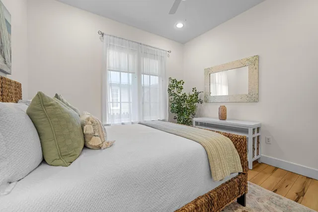 a bedroom with a bed and a potted plant