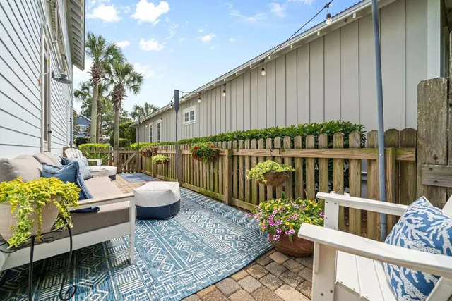 a bedroom with a bed a chandelier and a dresser