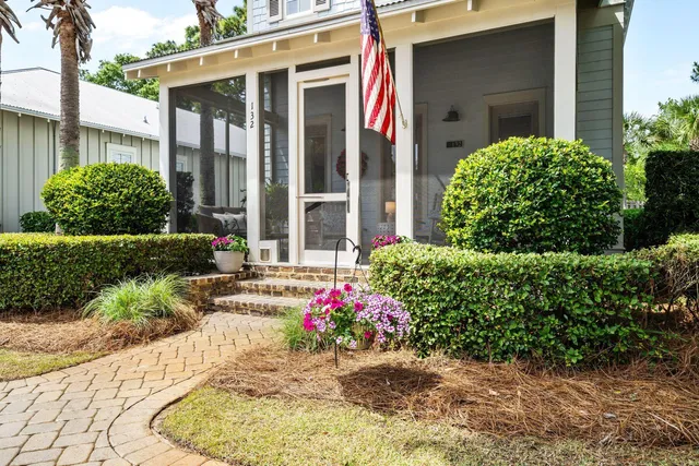 a house view with a garden and large trees