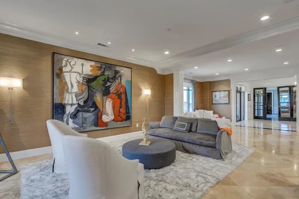 a living room with furniture and a painting