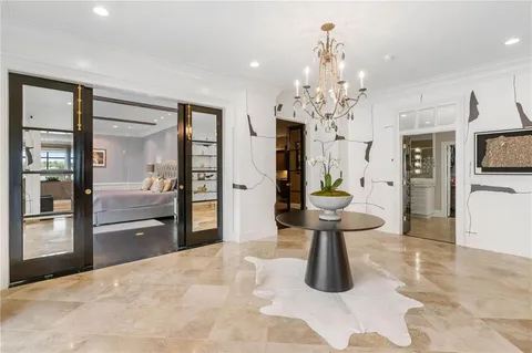 a bathroom with granite countertop shower a sink and a large mirror