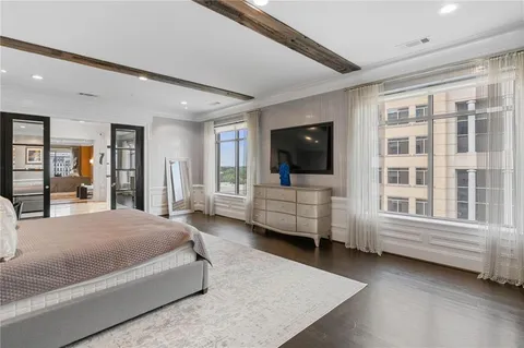 a spacious bedroom with a bed and a large window