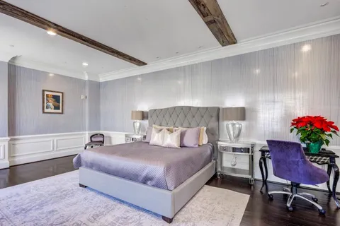 a bedroom with a bed and a potted plant