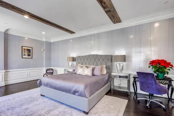 a bedroom with a bed and a potted plant