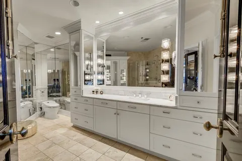 a bathroom with a double vanity sink mirror double and shower
