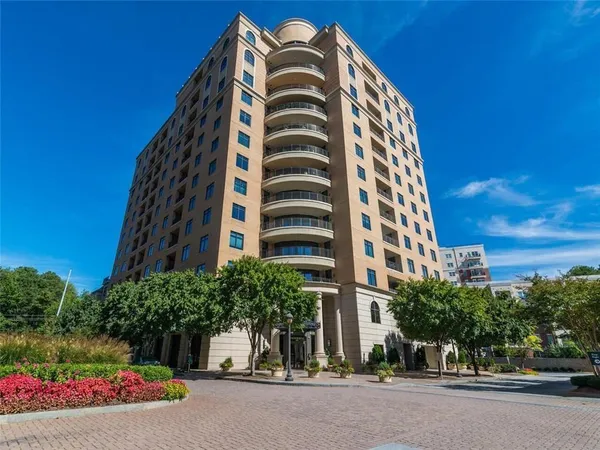 a view of a tall building next to a road