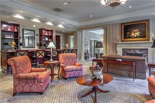 a living room with furniture a rug and a fireplace