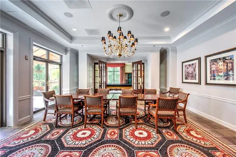 a view of a dining room with furniture wooden floor and chandelier