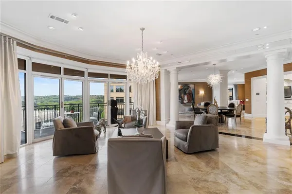 a living room with furniture and a chandelier