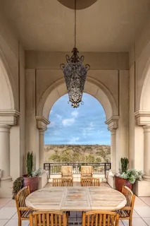 a dining room with a table chairs and a chandelier