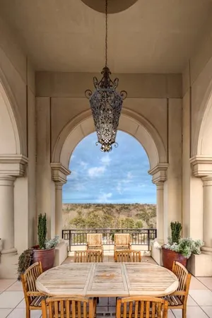 a dining room with a table chairs and a chandelier