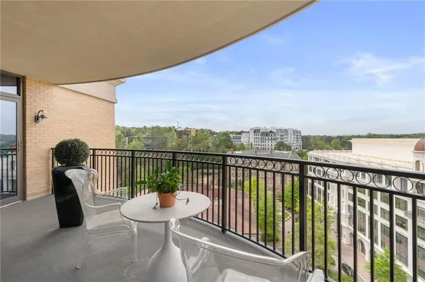 a balcony with an outdoor seating