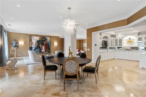 a dining room with furniture and a chandelier