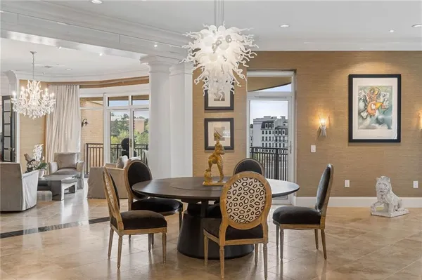 a view of a dining room with furniture wooden floor and chandelier