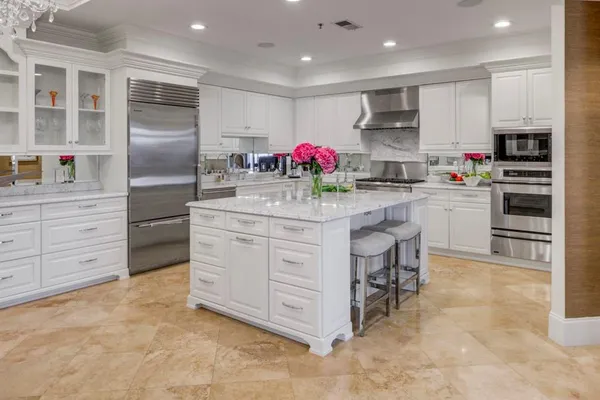 a kitchen with kitchen island cabinets and refrigerator