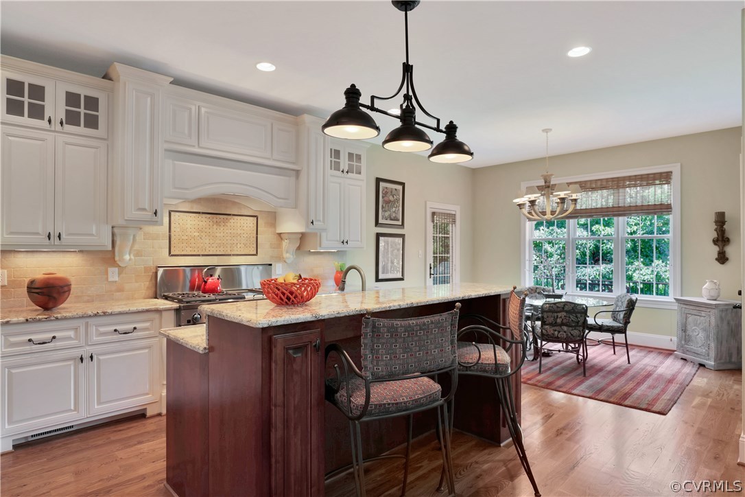 3830 Bircham Loop Midlothian, VA 23113 - Photo 12 of 33 a kitchen with stainless steel appliances granite countertop a sink a stove and a wooden floors