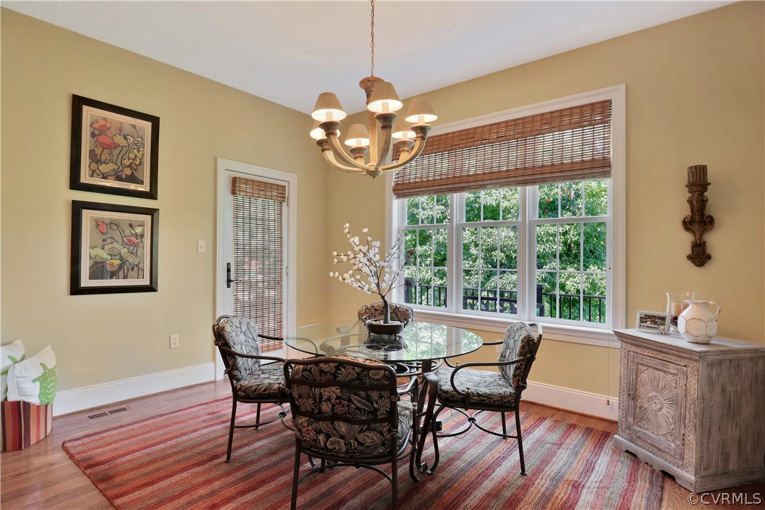 3830 Bircham Loop Midlothian, VA 23113 - Photo 8 of 33 a dining room with furniture a large window and wooden floor