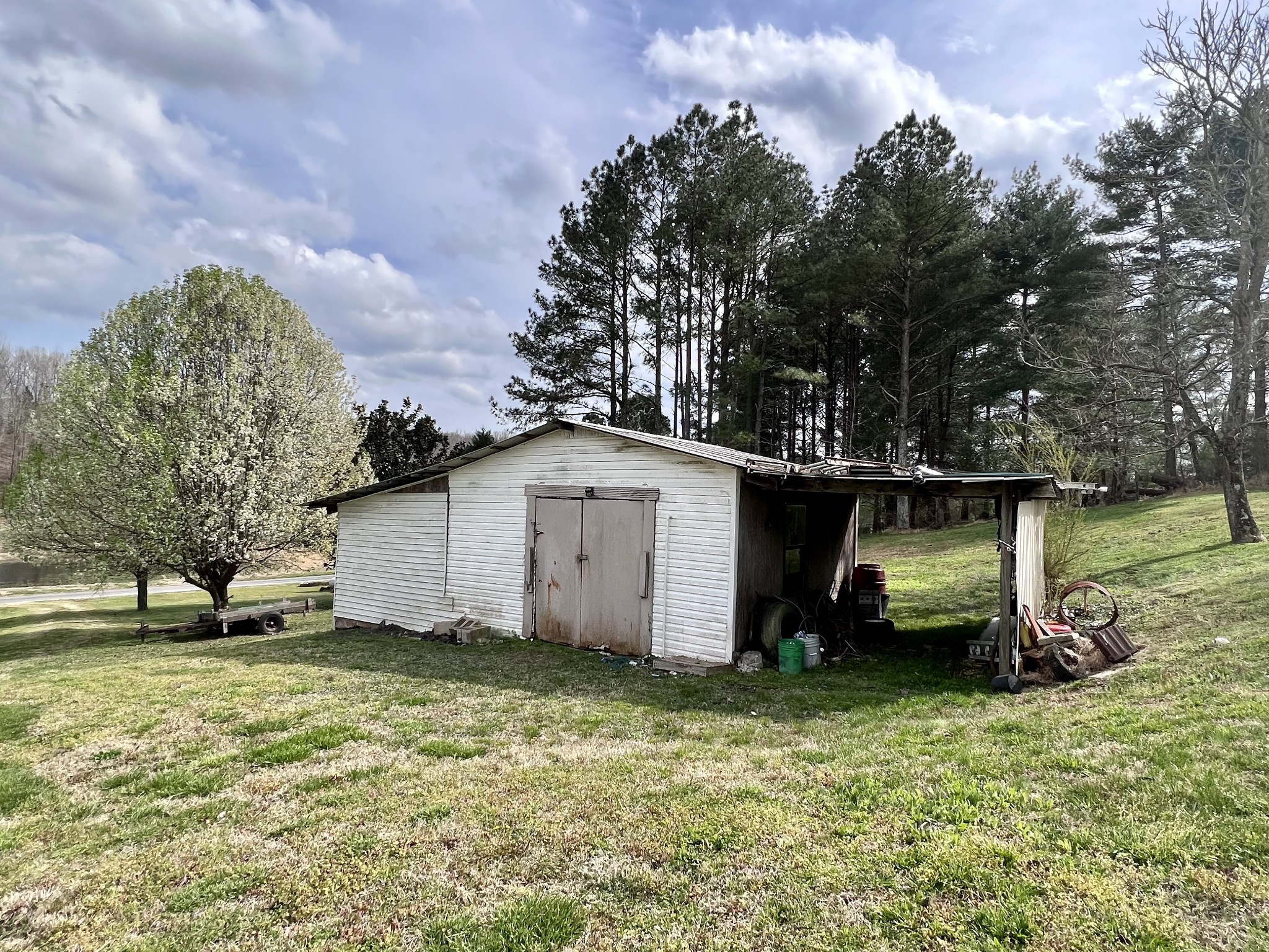 693 Littrell Road Loretto, TN 38469 - Photo 11 of 57 a white house that has a tree in front of it