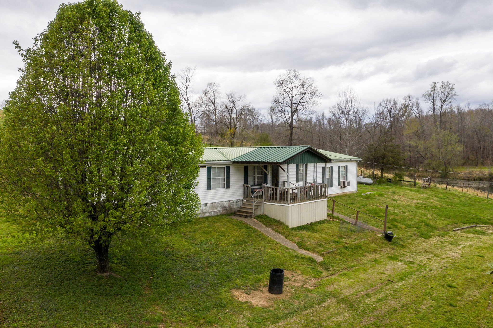 693 Littrell Road Loretto, TN 38469 - Photo 15 of 57 a house with green field in front of it