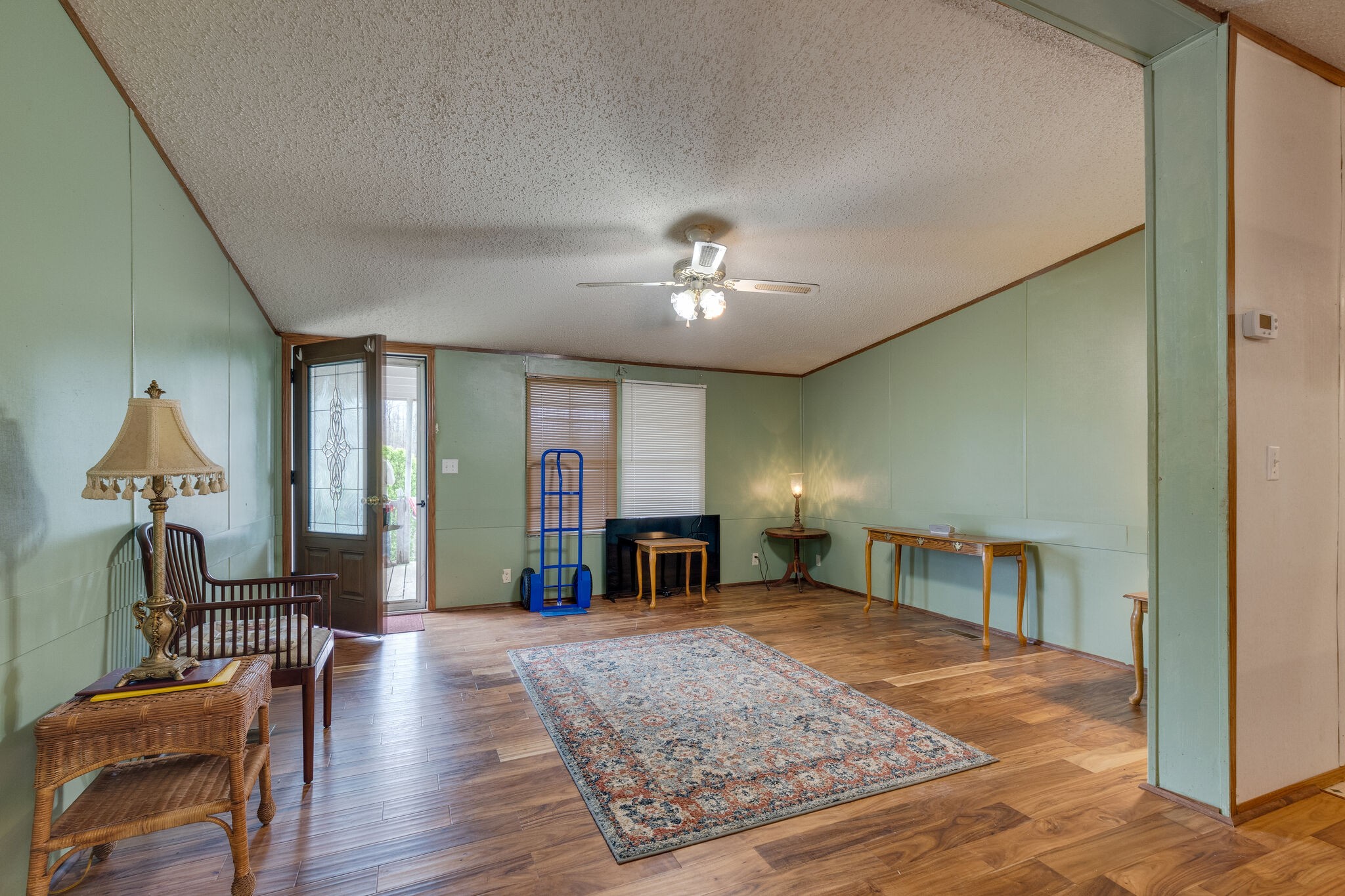 693 Littrell Road Loretto, TN 38469 - Photo 34 of 57 a view of a livingroom with furniture hardwood floor and a ceiling fan
