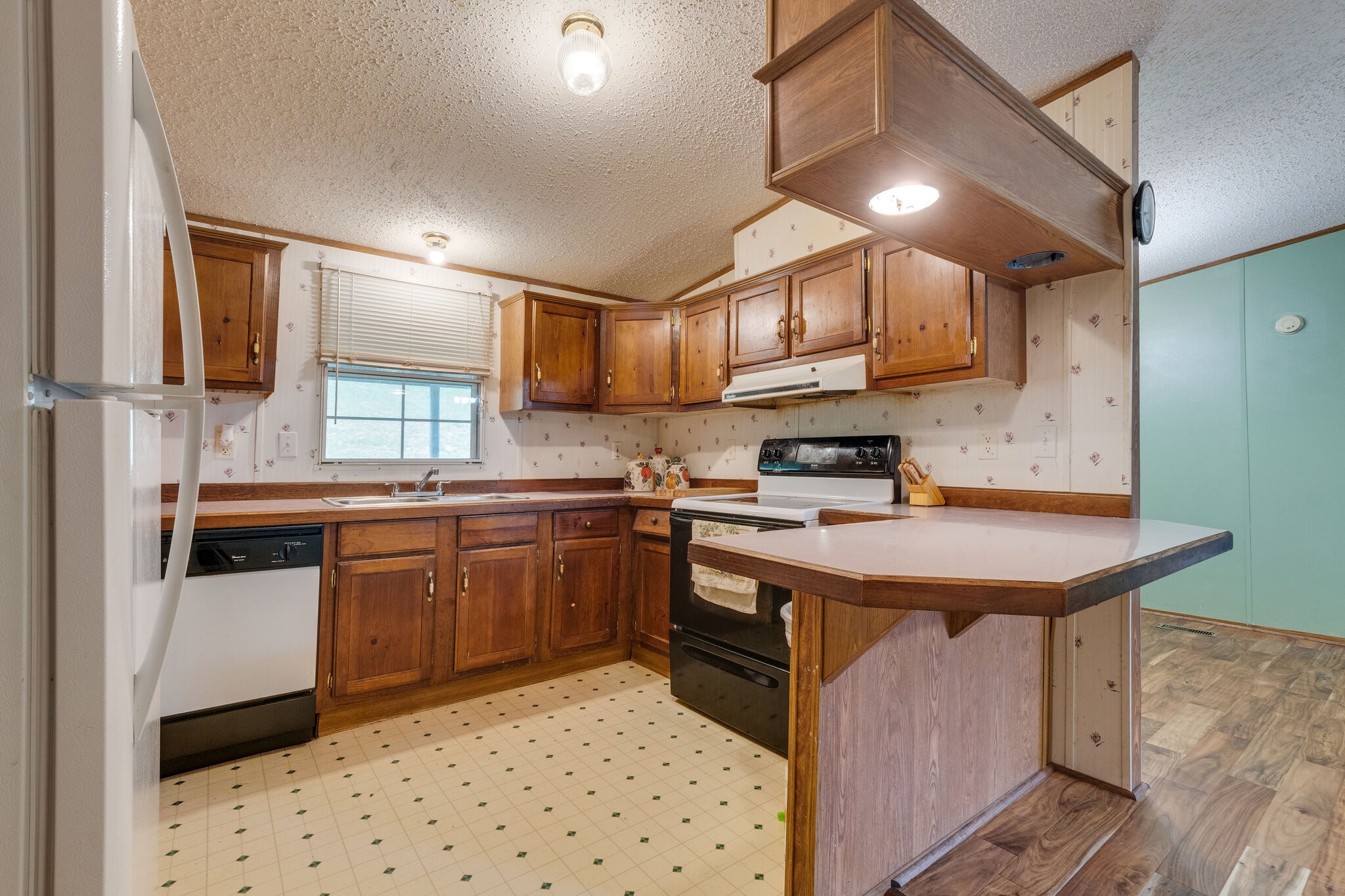 693 Littrell Road Loretto, TN 38469 - Photo 36 of 57 a kitchen with stainless steel appliances a sink a stove a refrigerator cabinets and a dining table