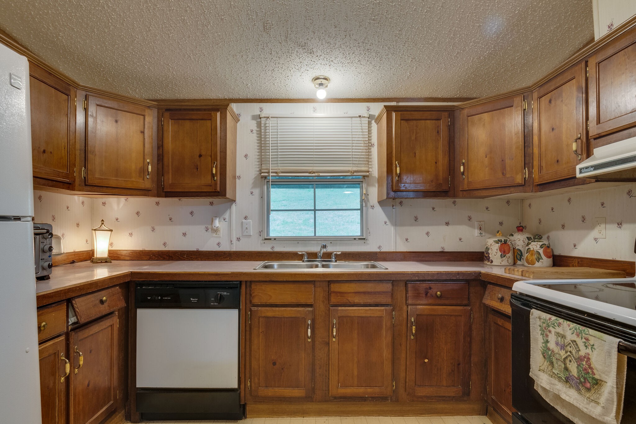 693 Littrell Road Loretto, TN 38469 - Photo 41 of 57 a kitchen with a sink a stove and cabinets