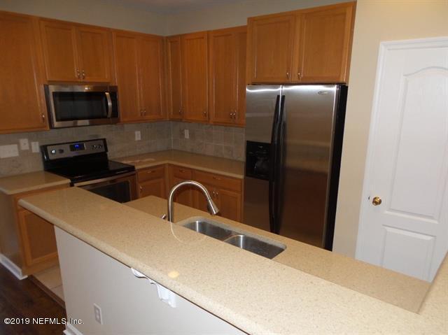 124 Bay Bridge Drive St. Augustine, FL 32080 - Photo 11 of 19 a kitchen with a refrigerator stove and microwave