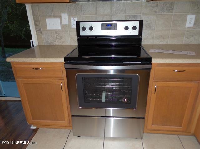 124 Bay Bridge Drive St. Augustine, FL 32080 - Photo 12 of 19 a stove top oven sitting inside of a kitchen