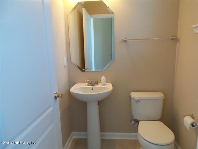 124 Bay Bridge Drive St. Augustine, FL 32080 - Photo 18 of 19 a bathroom with a toilet sink and mirror