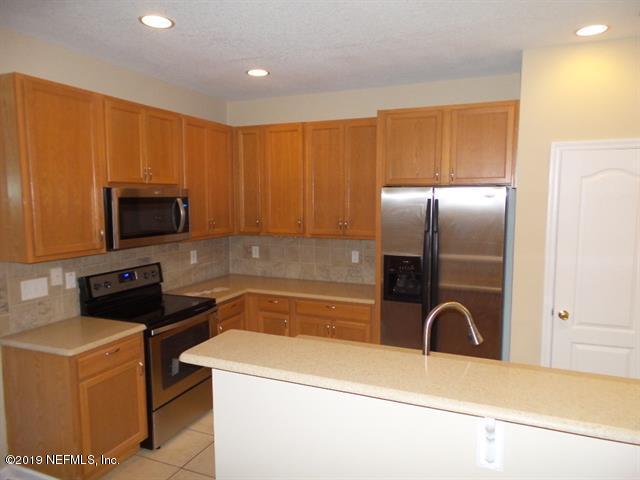 124 Bay Bridge Drive St. Augustine, FL 32080 - Photo 2 of 19 a kitchen with stainless steel appliances granite countertop a refrigerator a stove top oven a sink and dishwasher