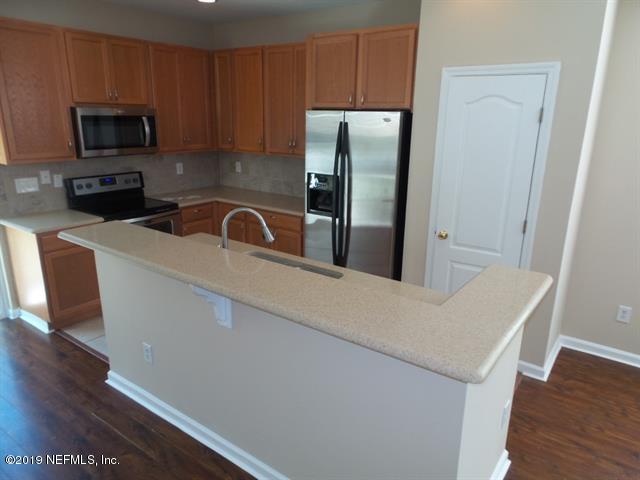 124 Bay Bridge Drive St. Augustine, FL 32080 - Photo 5 of 19 a kitchen with stainless steel appliances a refrigerator a sink a stove a microwave and cabinets