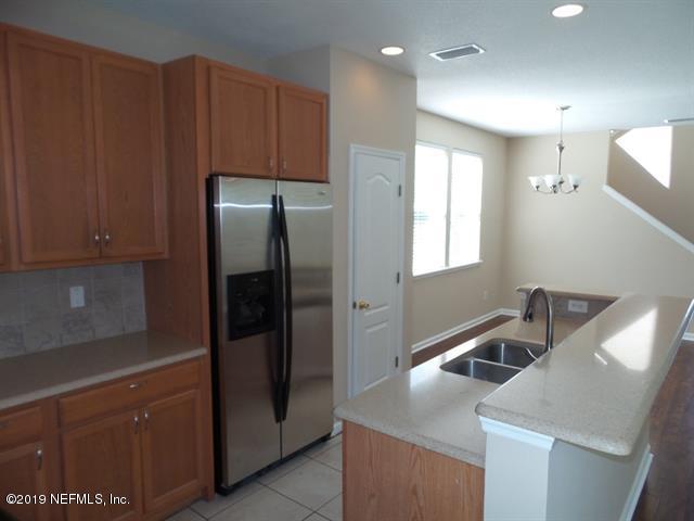 124 Bay Bridge Drive St. Augustine, FL 32080 - Photo 7 of 19 a kitchen with stainless steel appliances granite countertop a refrigerator and a sink