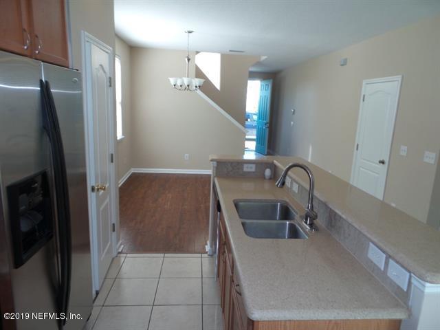 124 Bay Bridge Drive St. Augustine, FL 32080 - Photo 8 of 19 a kitchen with a refrigerator sink and cabinets