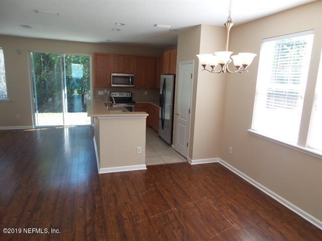 124 Bay Bridge Drive St. Augustine, FL 32080 - Photo 10 of 19 a view of a kitchen with wooden floor electronic appliances and windows