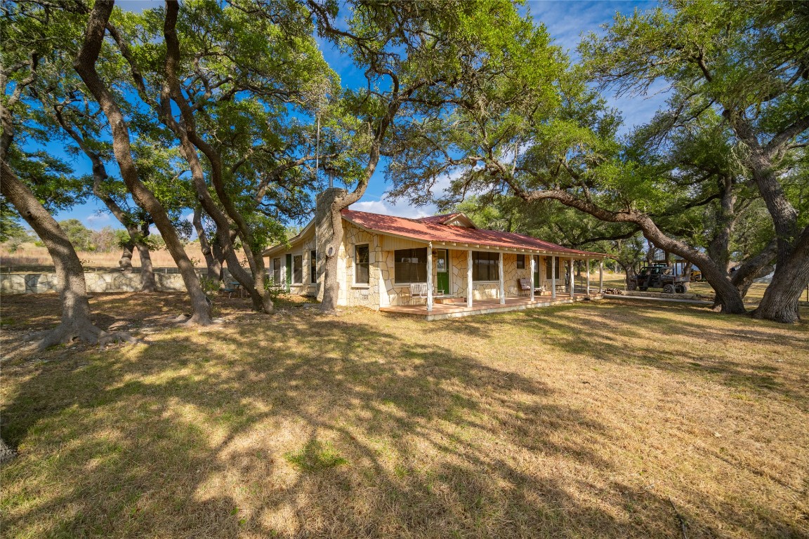 518 Curly H Ranch Road Dripping Springs, TX 78620 - Photo 2 of 40 a front view of a house with a garden
