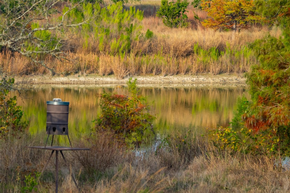 518 Curly H Ranch Road Dripping Springs, TX 78620 - Photo 24 of 40 a view of a lake with a big yard