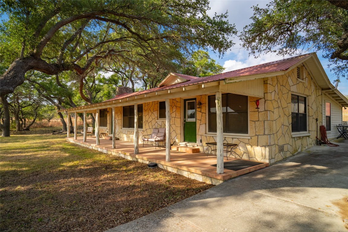 518 Curly H Ranch Road Dripping Springs, TX 78620 - Photo 26 of 40 a front view of a house with a garden
