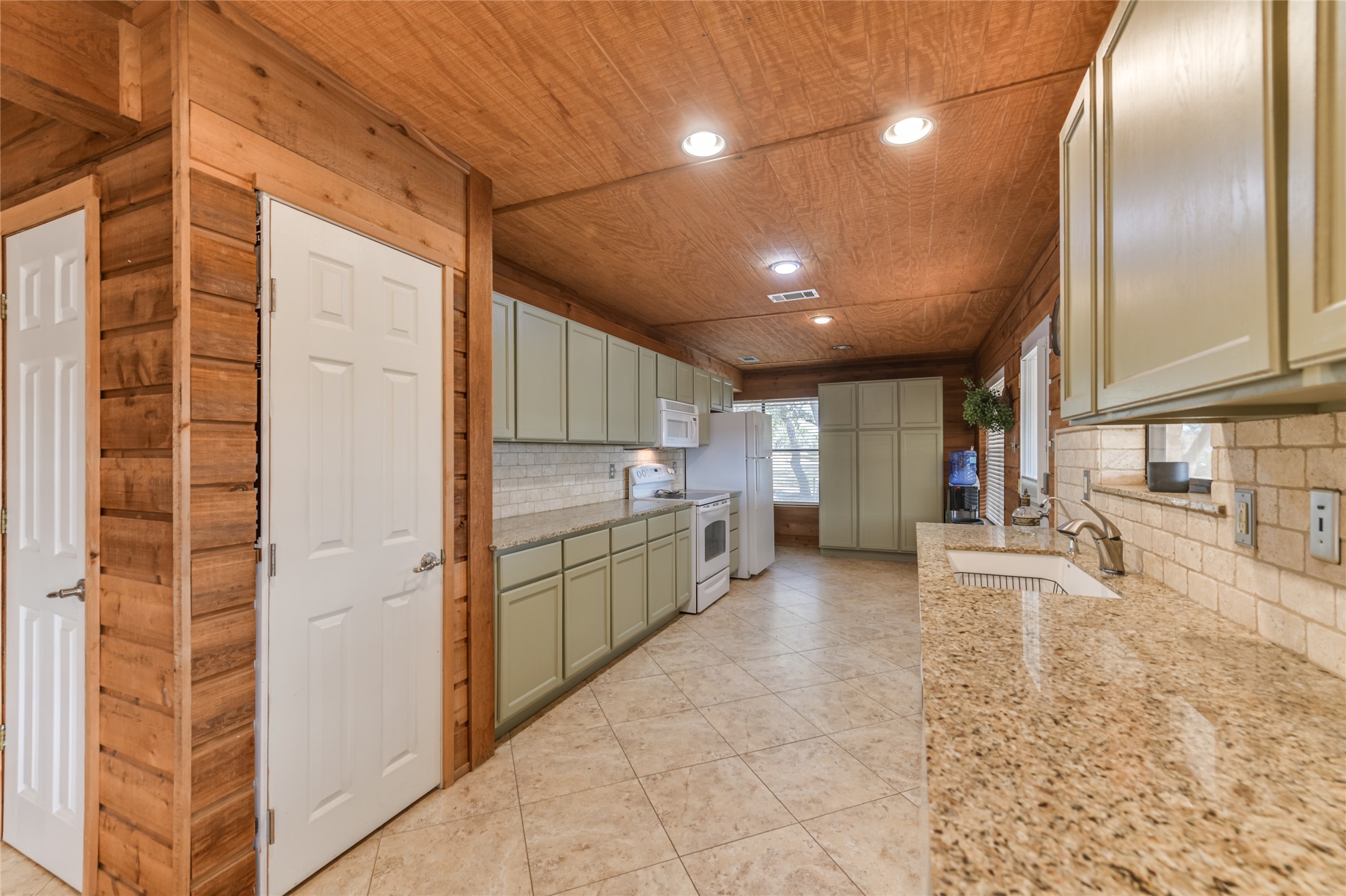 518 Curly H Ranch Road Dripping Springs, TX 78620 - Photo 27 of 40 a view of a kitchen with a sink and cabinets