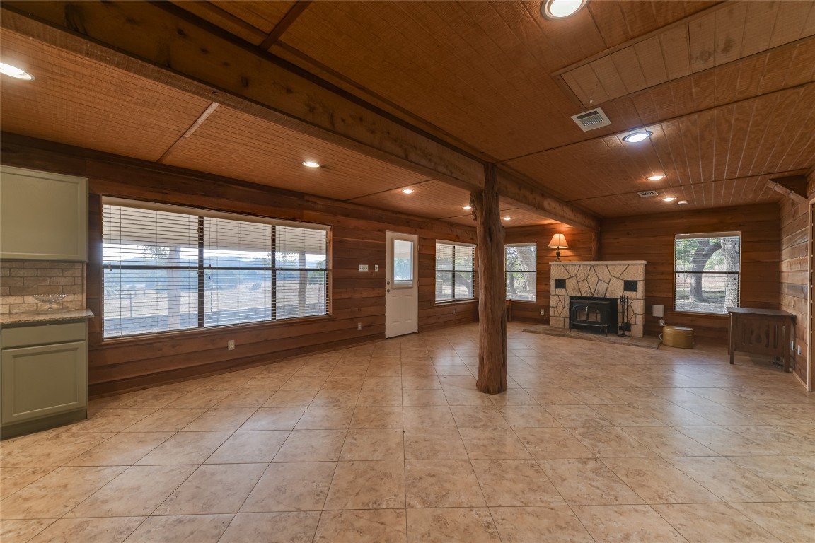 518 Curly H Ranch Road Dripping Springs, TX 78620 - Photo 28 of 40 a view of an empty room with a fireplace