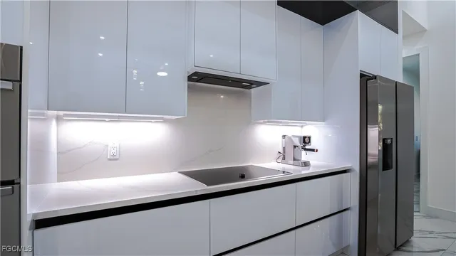 a kitchen with a sink and a refrigerator