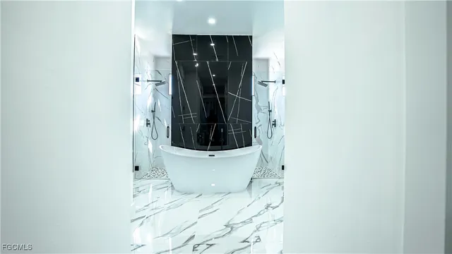 a white toilet sitting next to a shower