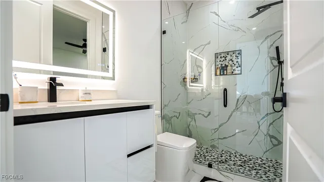 a bathroom with a sink toilet and shower