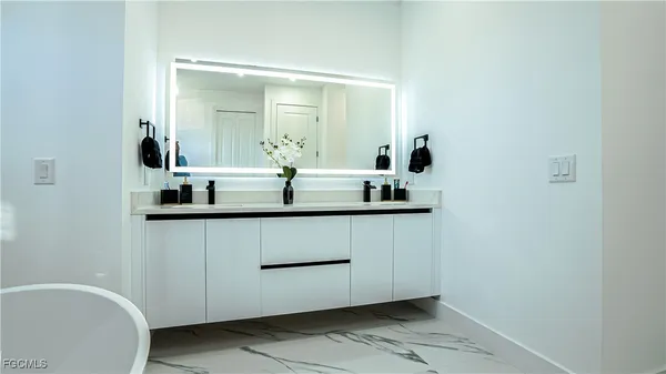 a white toilet sitting next to a shower